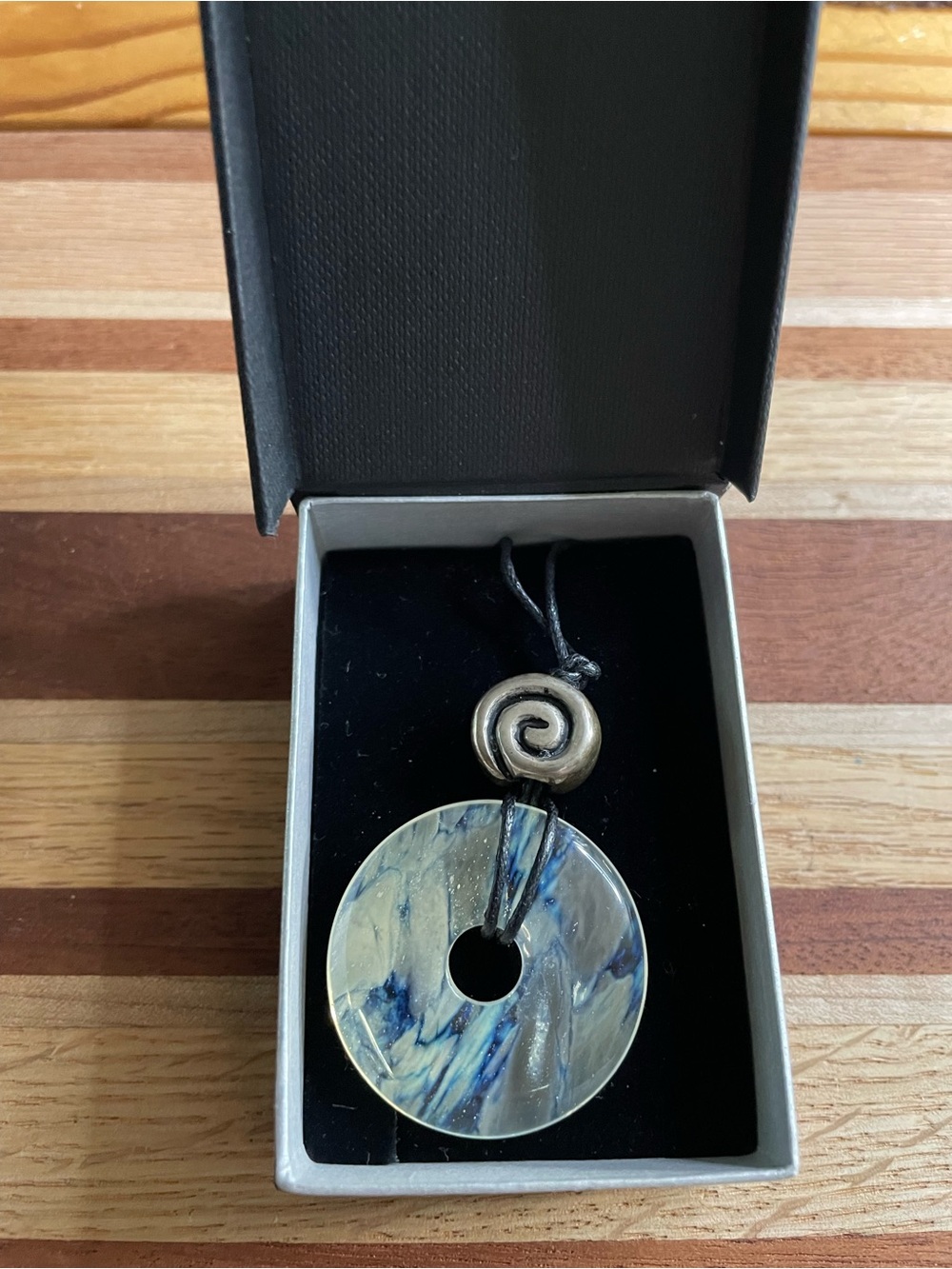 Irish Quartz Donut stone with a swirl made of silver over pewter black cord i28”